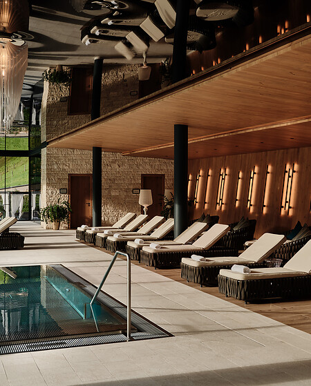 Indoor Pool area with relaxation sunbeds